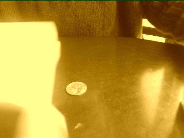 The shaker is gone through the table, but the quarter is still there!