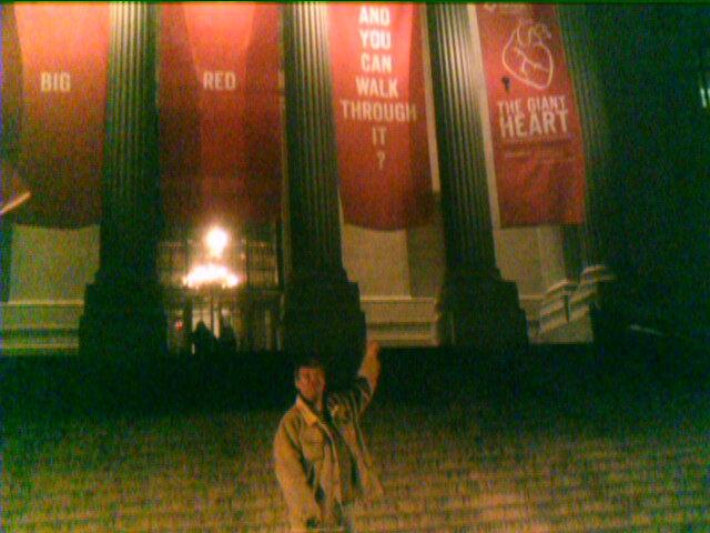 Very grainy long shot of Bob in front of Museum
